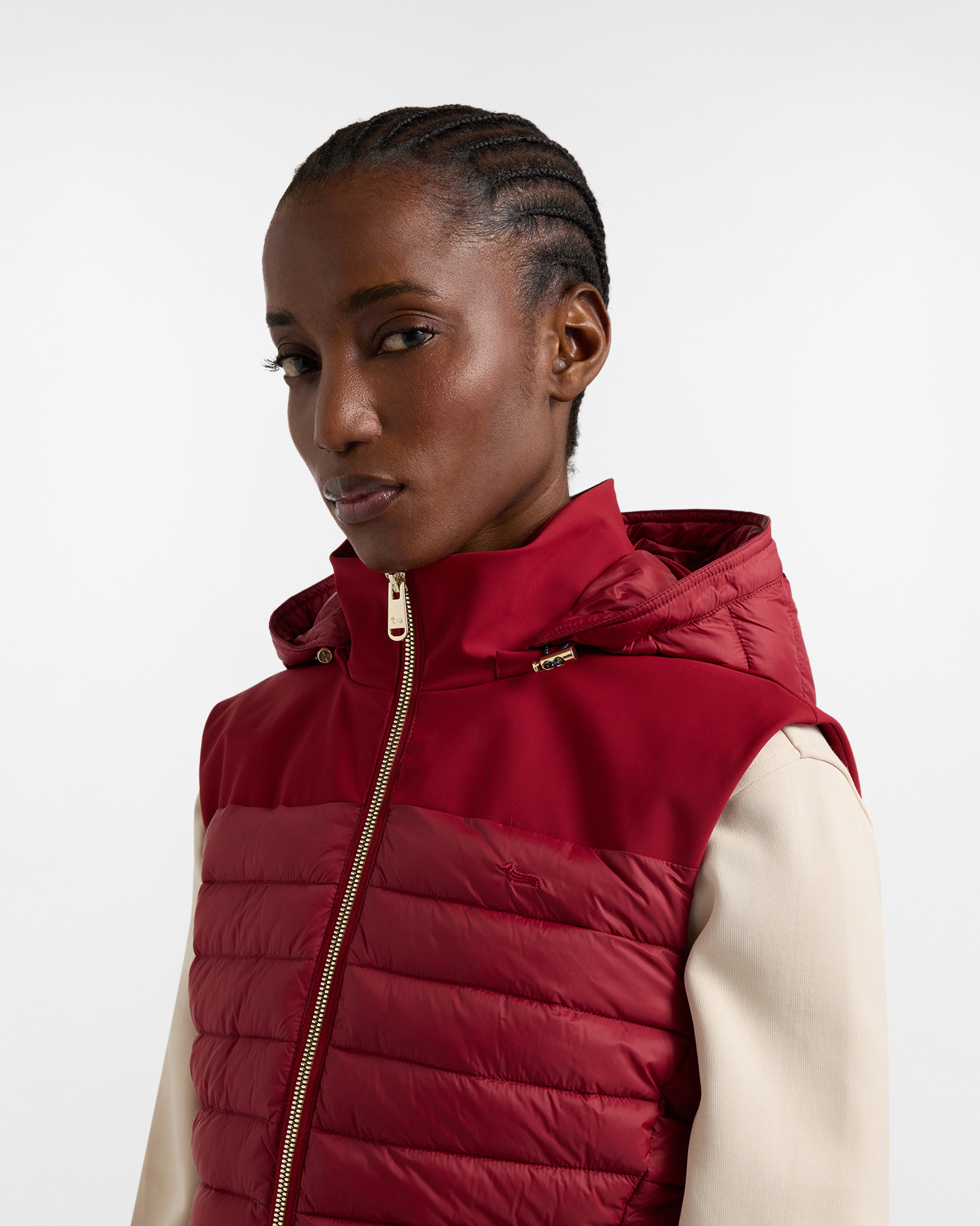 Woman wearing red padded vest with beige sleeves